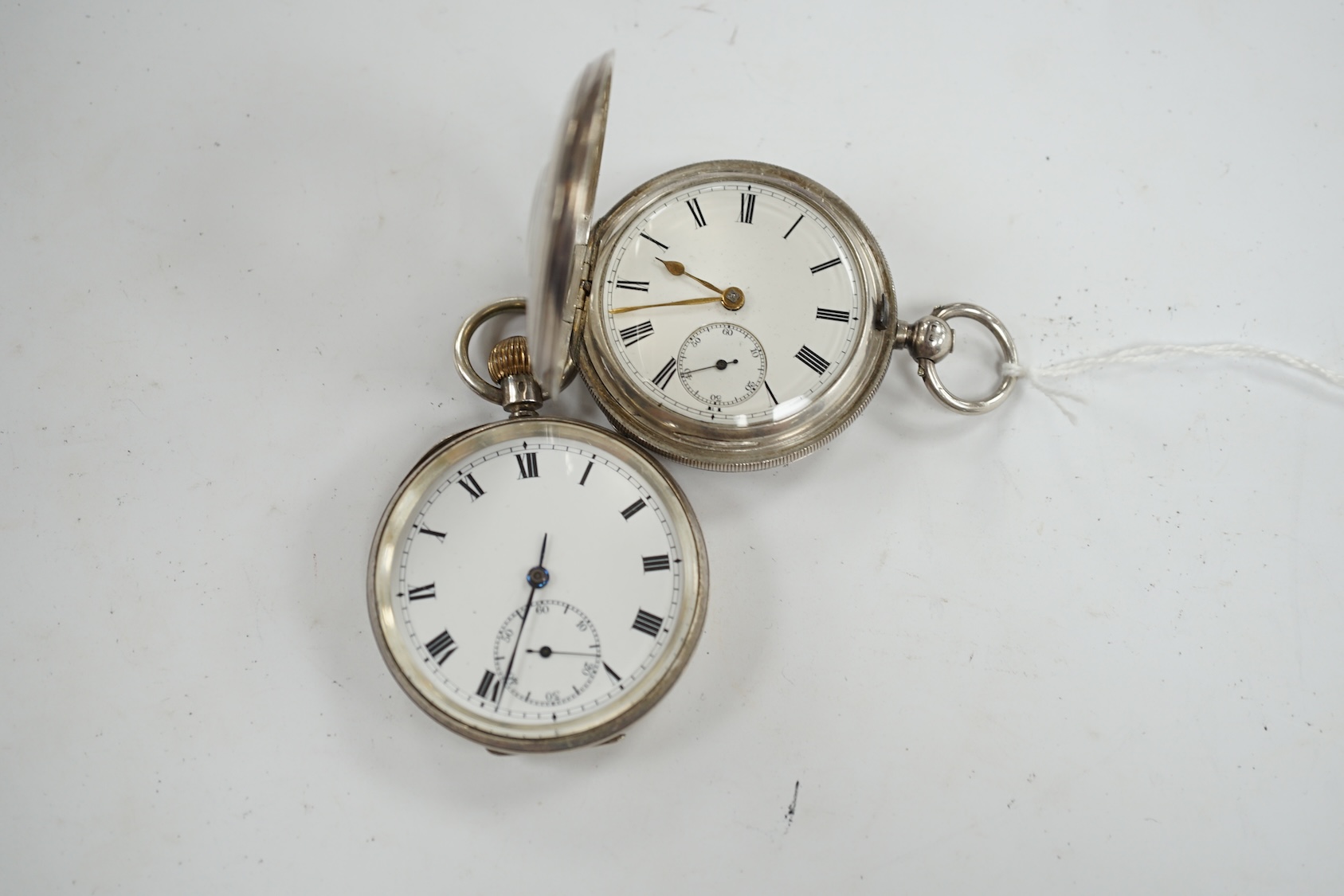 A late Victorian silver half hunter pocket watch and a later silver open faced pocket watch. Condition - poor to fair